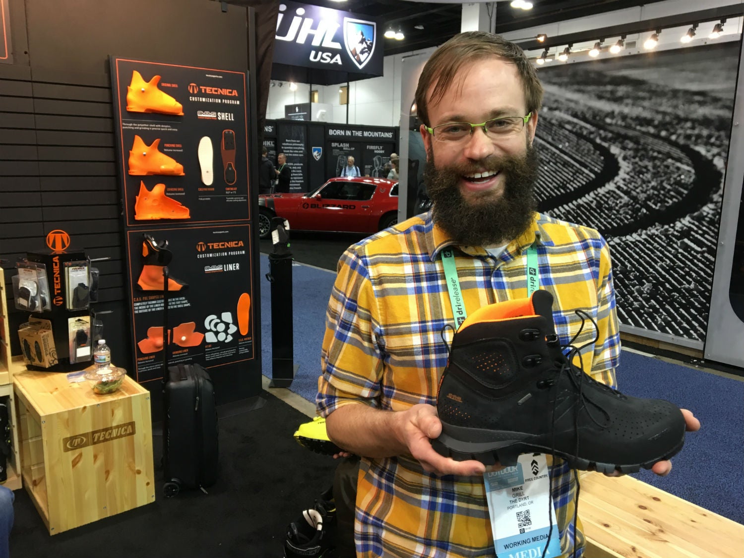 holding tecnica's custom boots at outdoor retailer