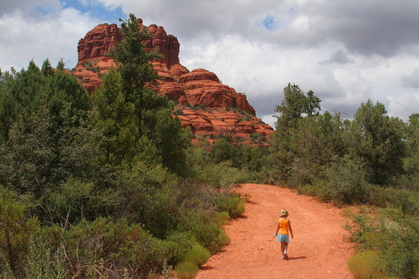 Hiker walking Manzanita, a Sedona AZ Campground. 