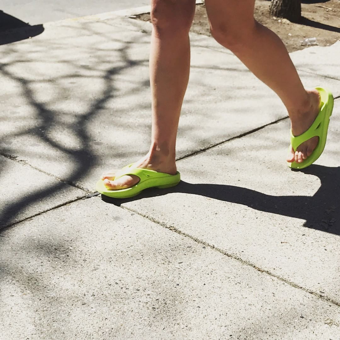Women walking in oofos recovery sandals.