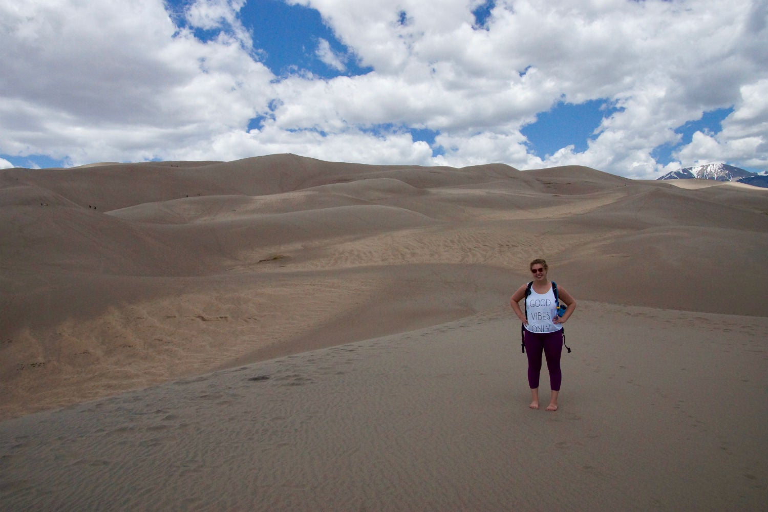 kelsey and sand dunes on her budget camping trip