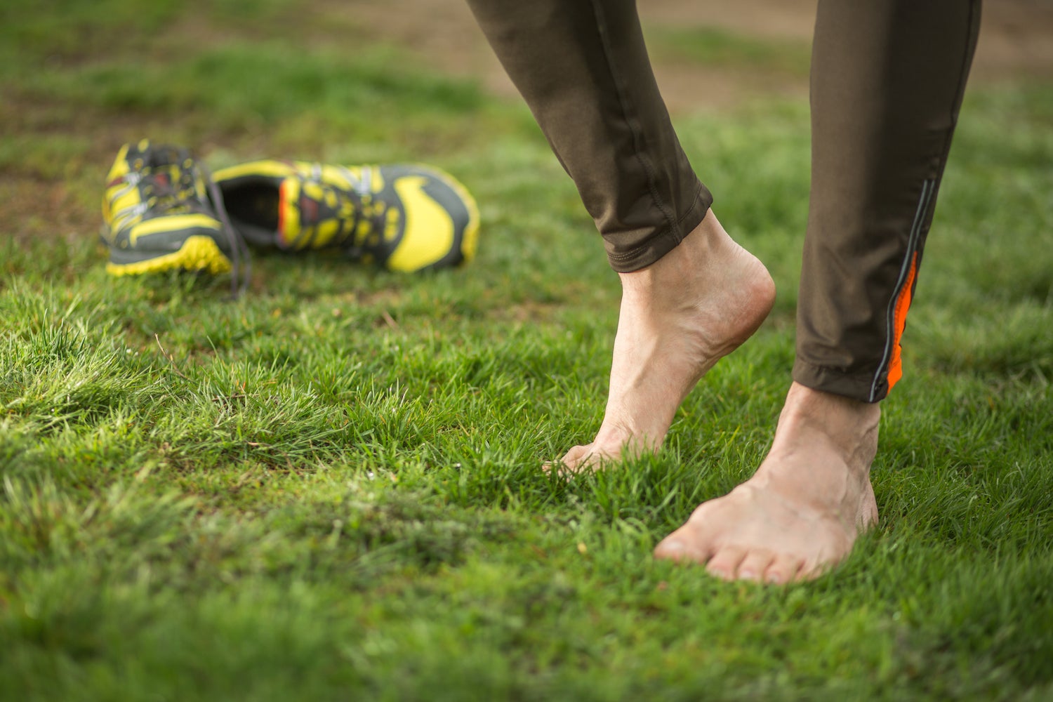 feet stretching on the grass after trail running