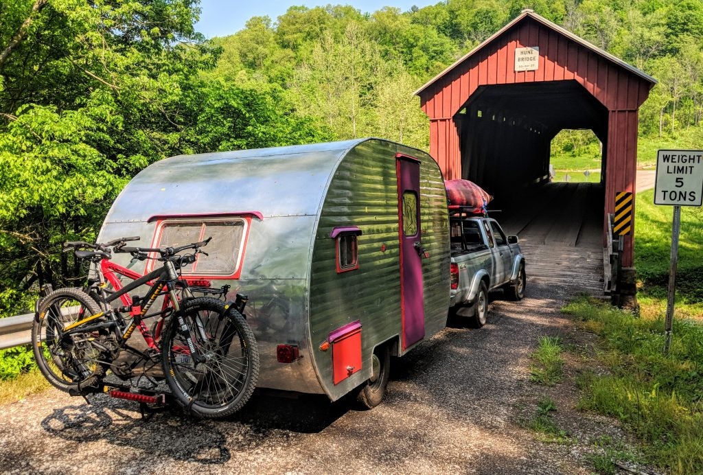 canned ham camper trailer driving across old bridge