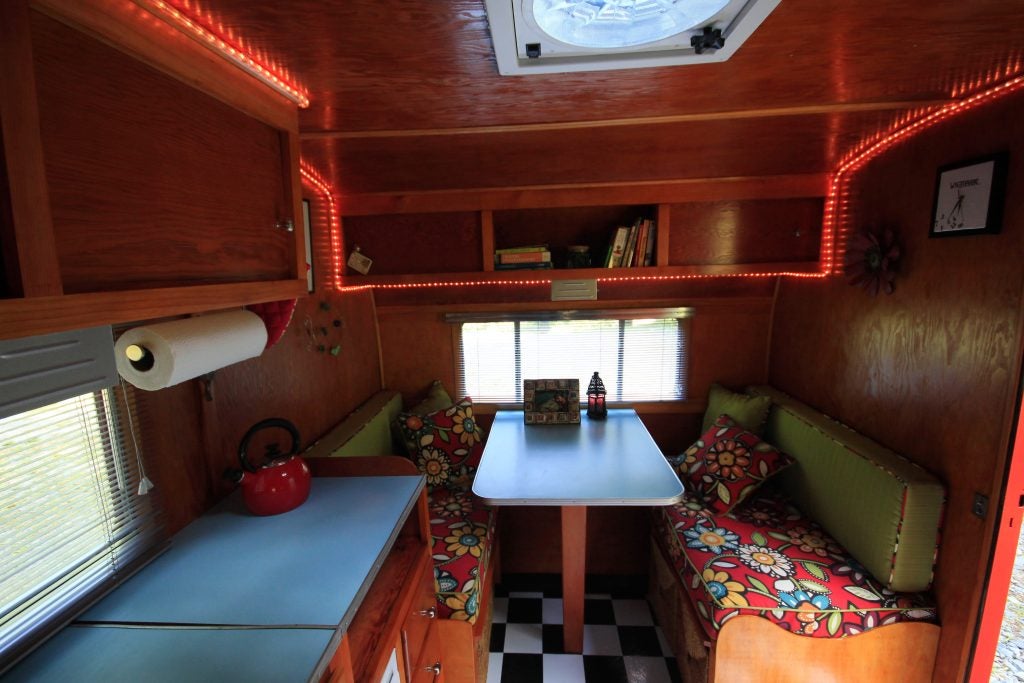 red led rope light decorates the interior of a camper trailer