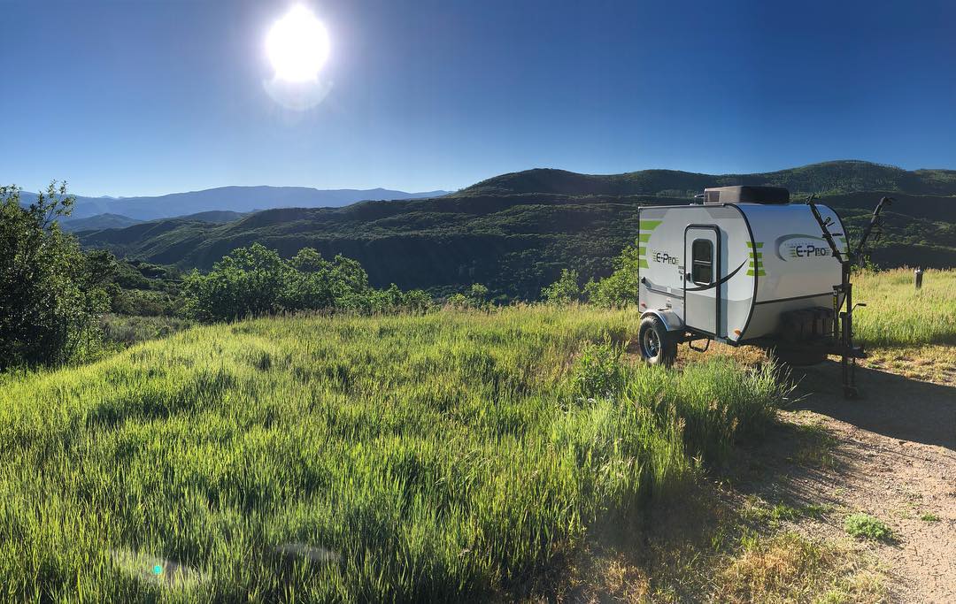 micro travel trailers in a field from nature dens