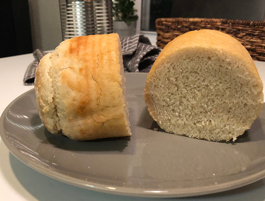 a campfire bread loaf split in half on a dinner plate