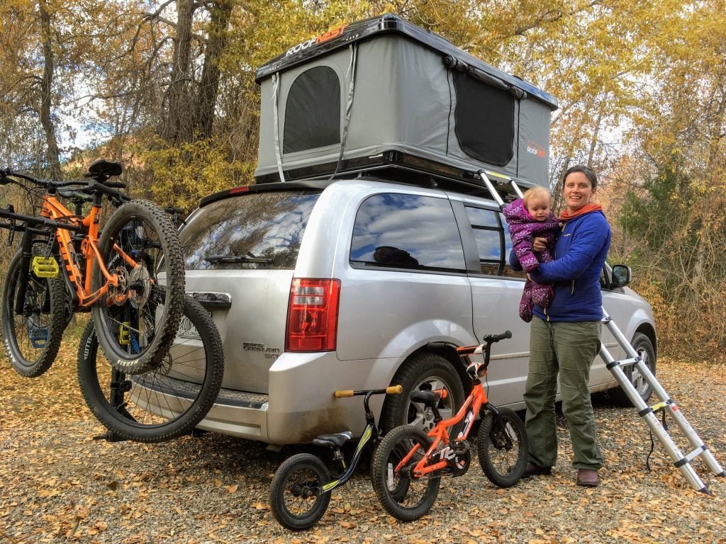 mom and daughter pose in front of roofnest tent installed on a mini van