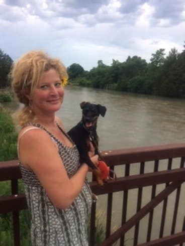 camper and her dog overlooking a wide river