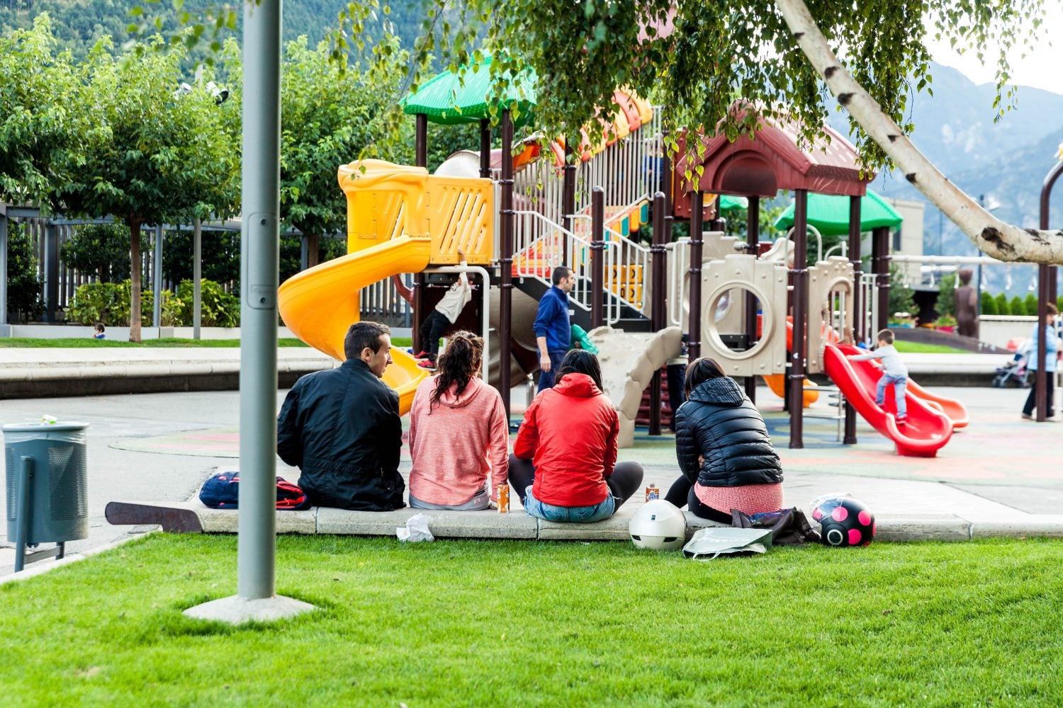 parents waiting on the sidelines at a kids playground