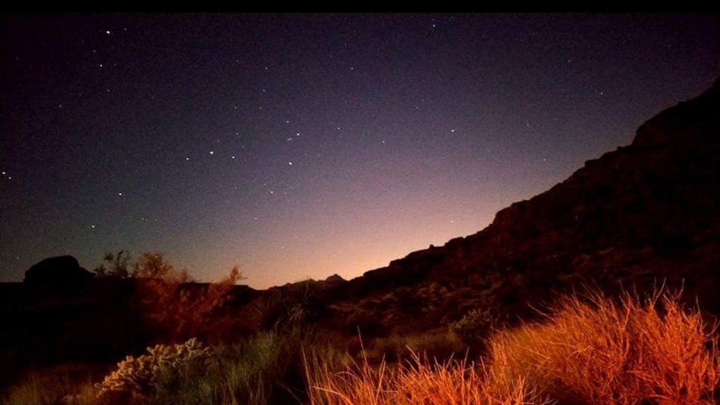 the starry night sky over a grassy desert in california