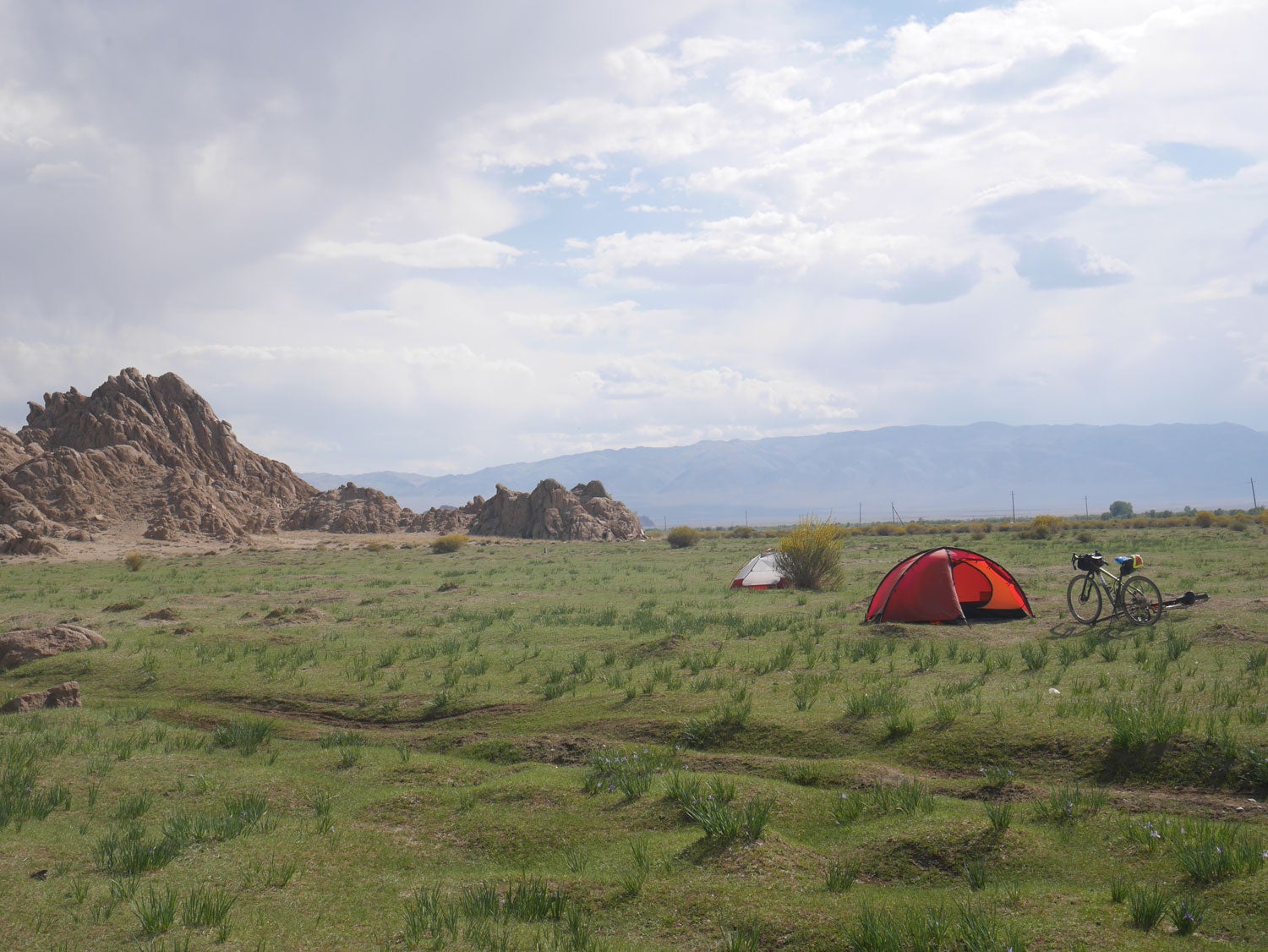 a tent rests in an open field