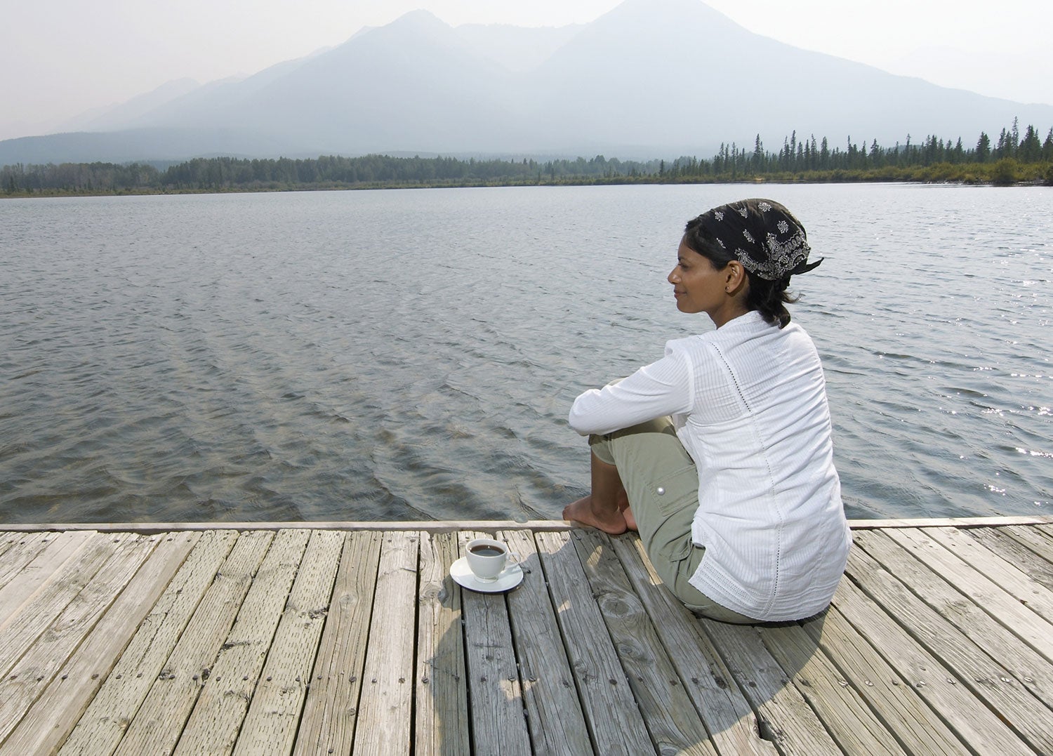 woman engaging in wilderness therapy on a lakeside dock