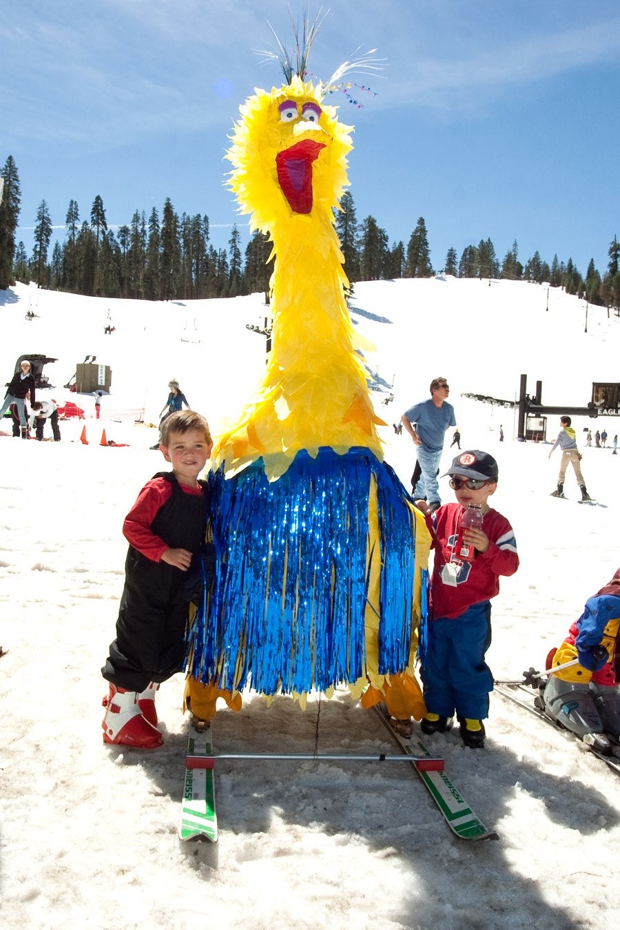 two young boys pose with big bird puppet during Springfest at Badger Pass
