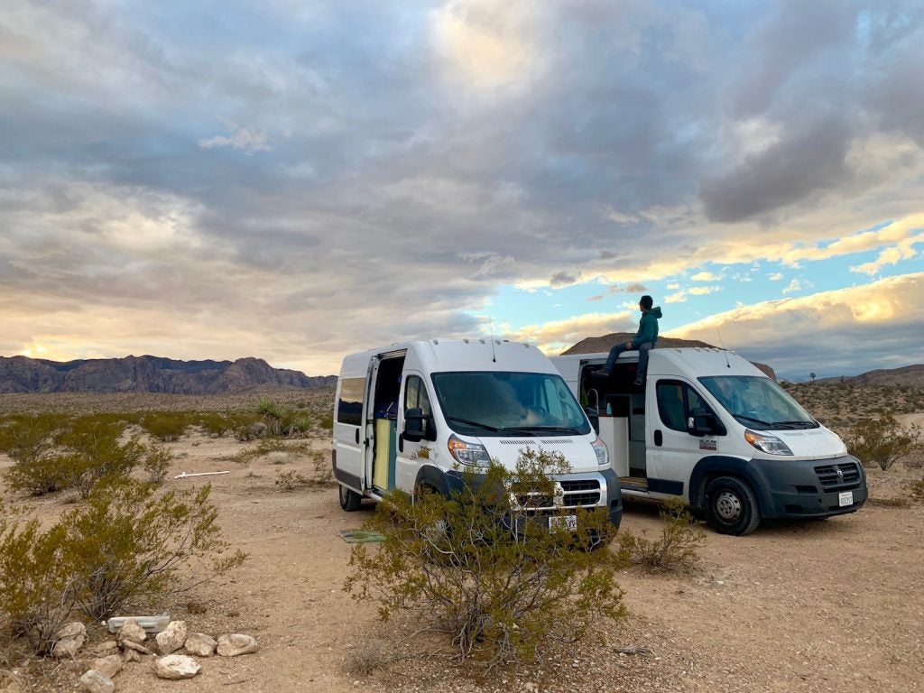 campervans in the desert before sunset