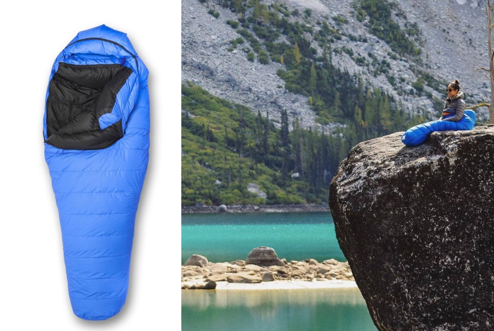 wide shot of women resting on cliff beside glacial water in her blue sleeping bag