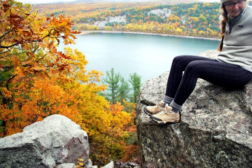Girl looking over panoramic view of lake during fall 