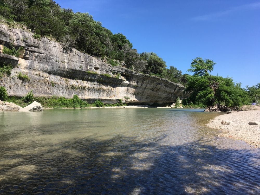 A beach and rock wall along the Guadalupe River in Texas 