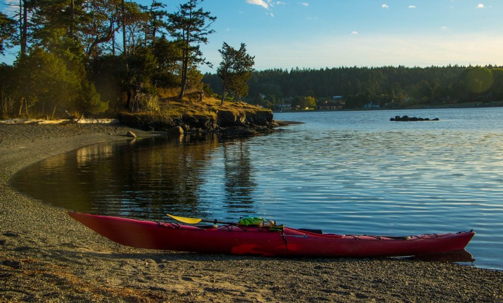 Kayak sits on shore of on of the San Juan islands