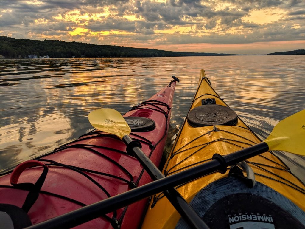 Two kayaks together at sunset 