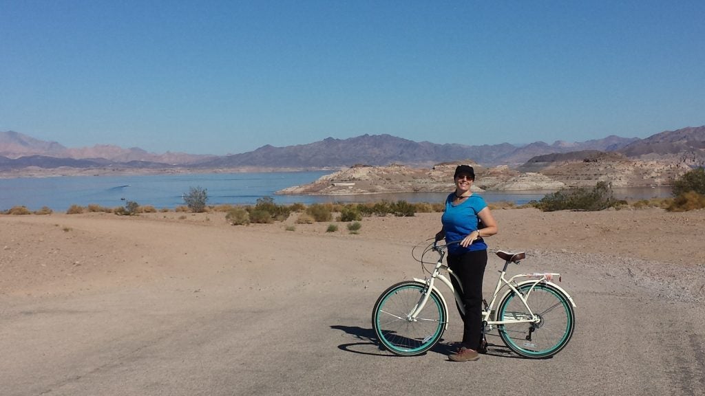 a biker poses on boulder beach at lake mead in nevada