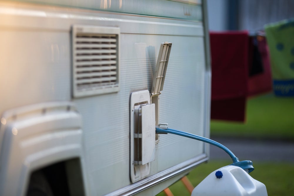 jug of water connected to an external spout on an rv