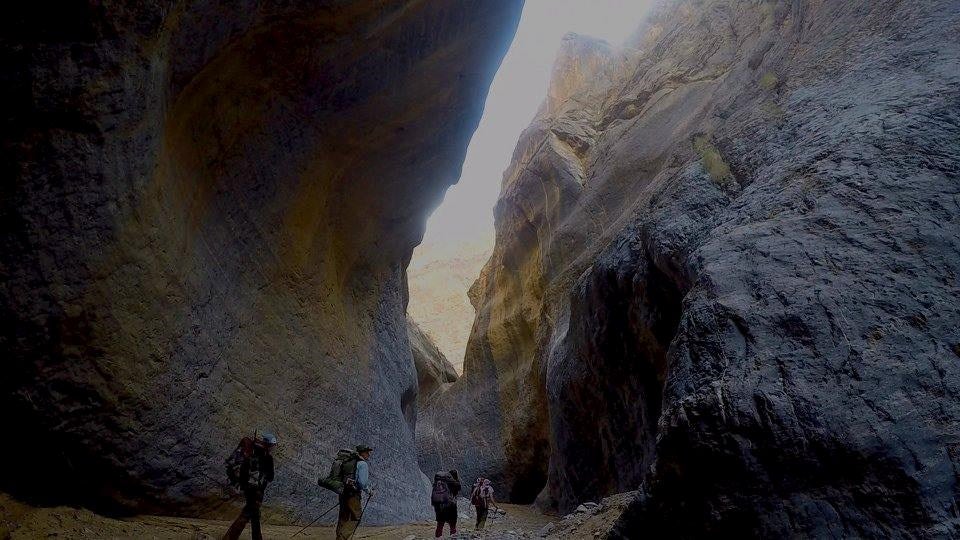 backpackers traverse through canyons in death valley national park