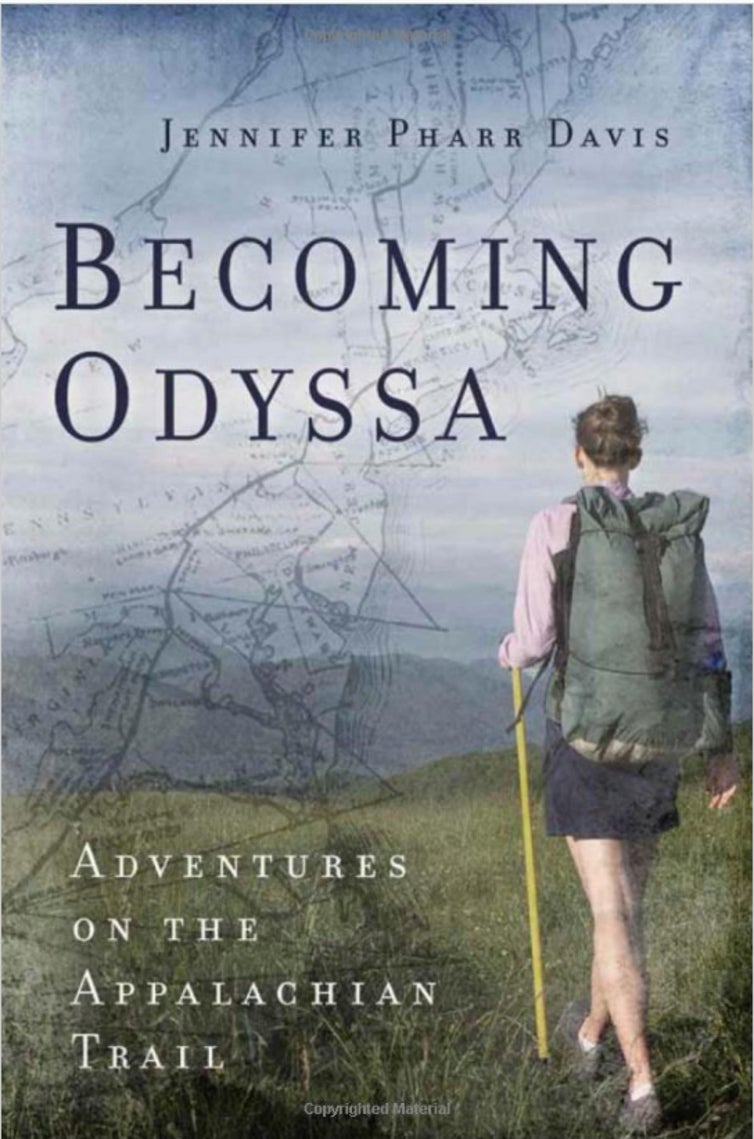 a woman hikes on grass on a book cover