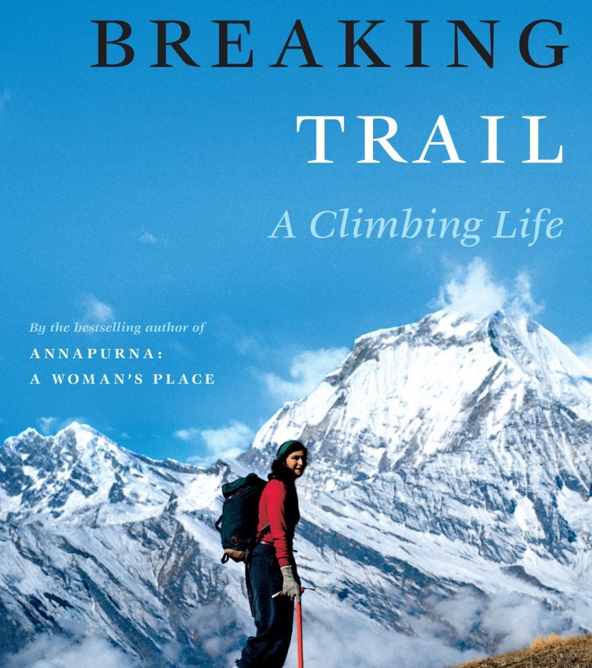 female hiker in red treks up mountainside on breaking trail book cover