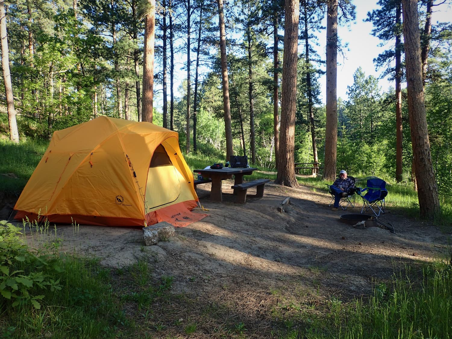 yellow tent in forest campsite near mount rushmore