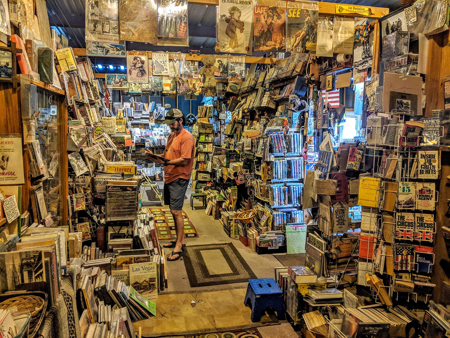 The interior of a book store in Quartzsite, AZ, with a man reading a book