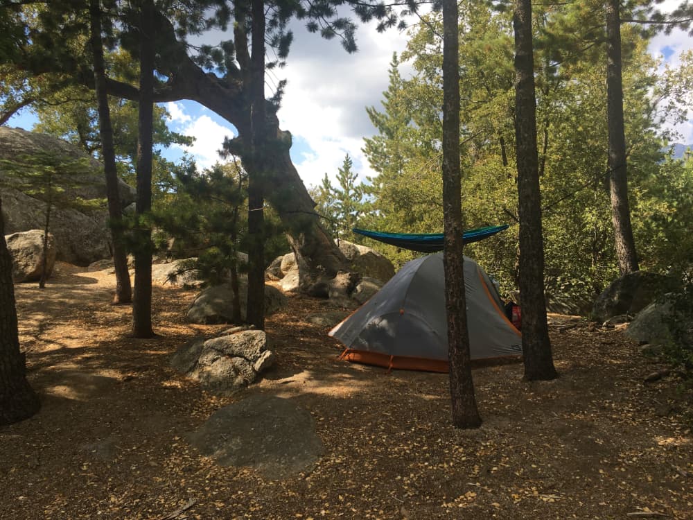 gray and orange tent and green hammock set up at yellow post campsite in san bernardino national forest