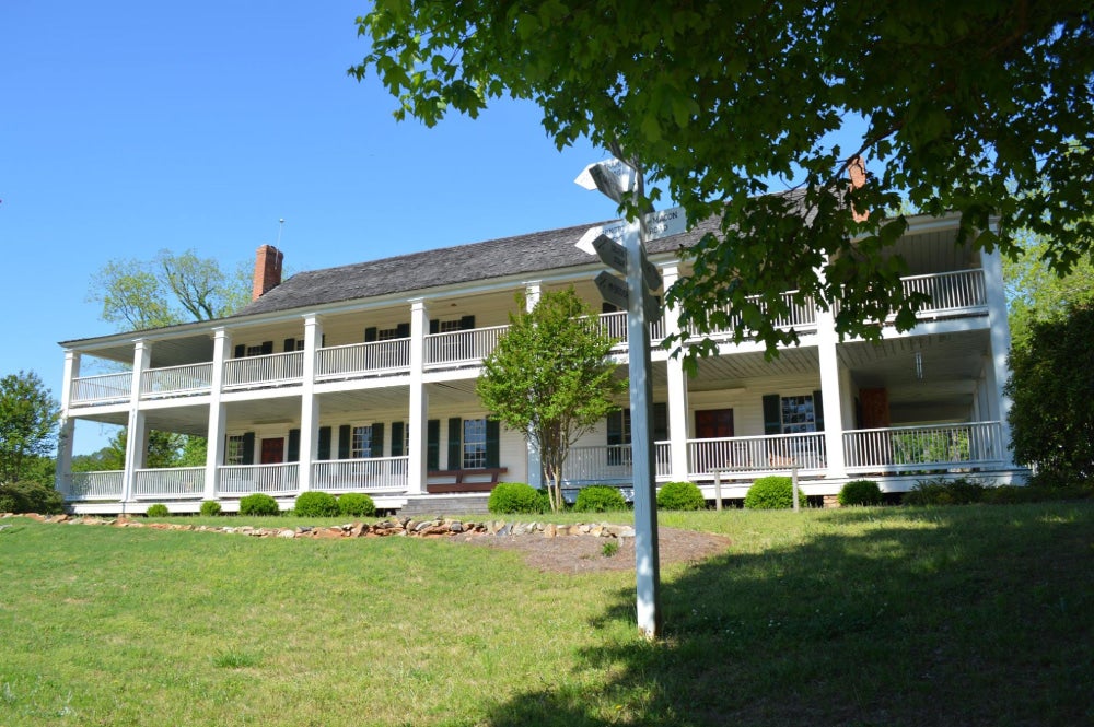 The Indian Springs Hotel & Museum with white beams and walls and gray roof