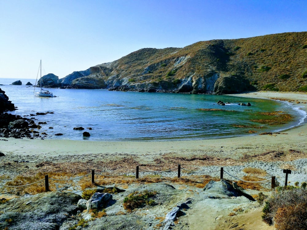 Panoramic view of the catalina island coastline mountains with a sailboat in the water