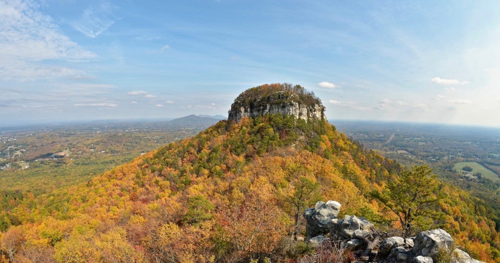 Panoramic view of Pilot Mountain, in North Carolina's Pilot Mountain State Park with fall foliage surrounding it