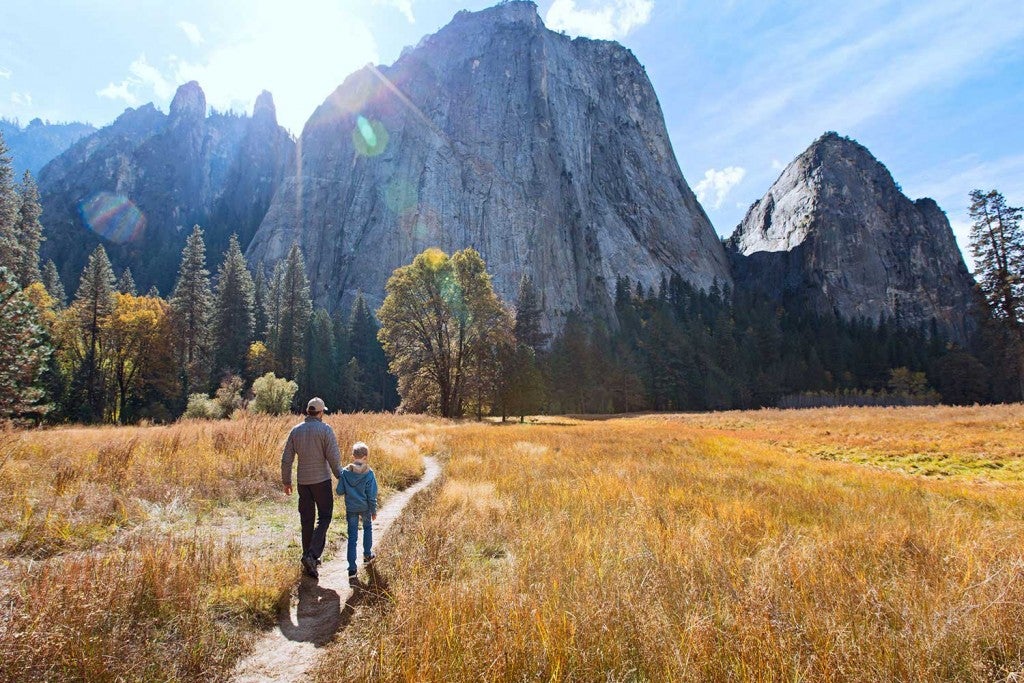 Father and son hiking below half dome in yosemite.