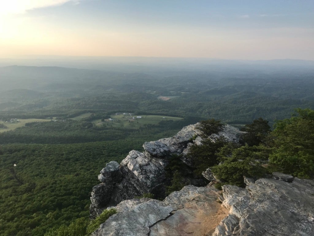a panoramic view of the valley surrounding north carolina's Hanging Rock State Park at sunset