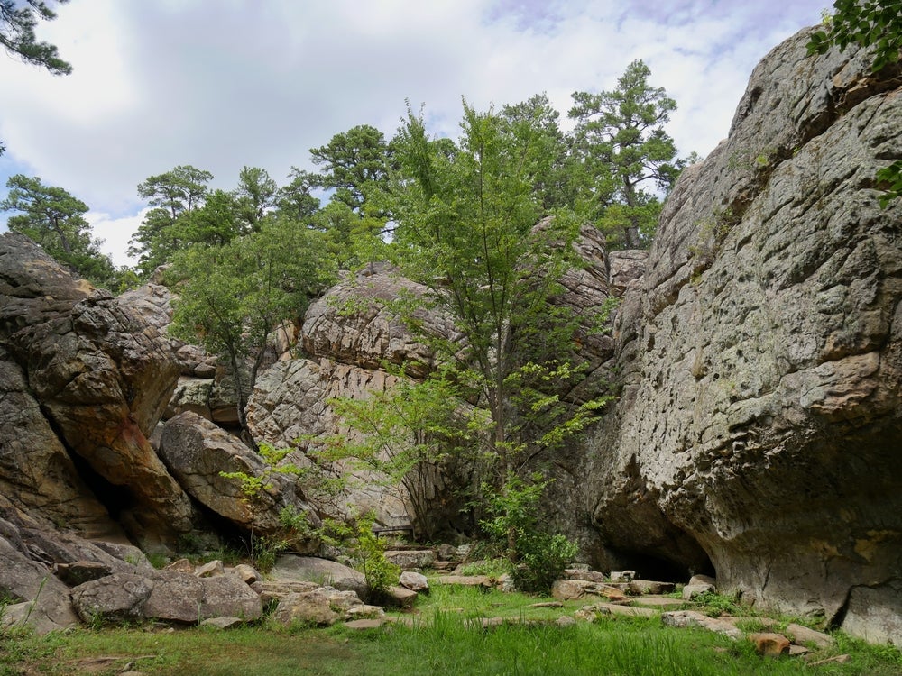 Landscape of large cliffs faces and trees in Robbers Cave State Park.