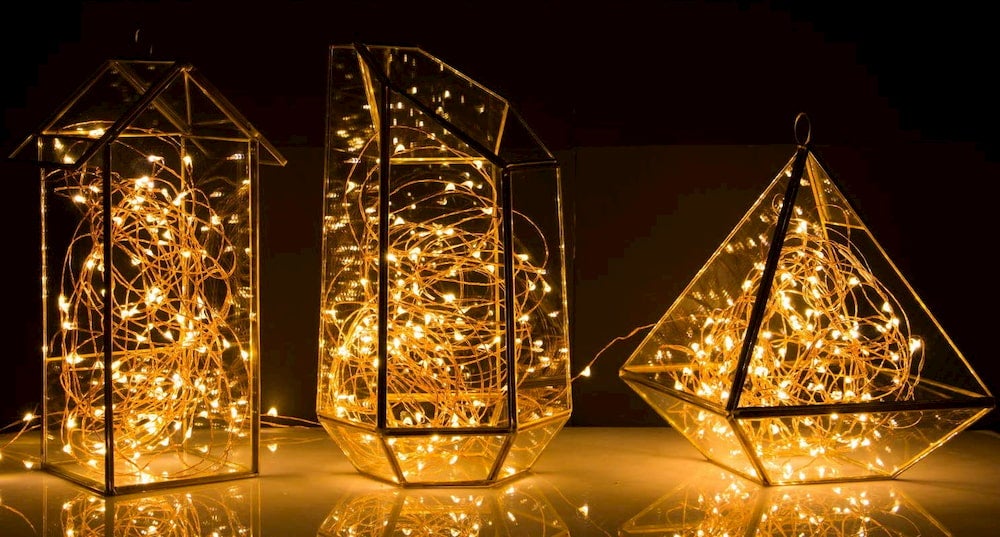 Copper wire lights in glass cases of different shapes