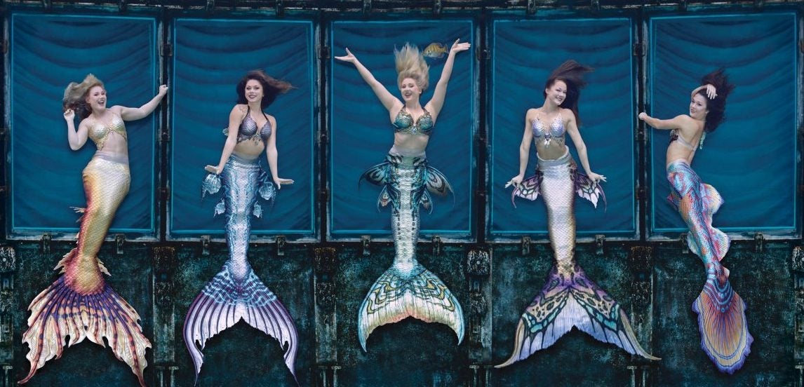 Aerial view of five Weeki Wachee Mermaids with colorful tails