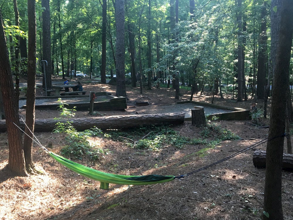 Campground with forest and green hammock in foreground