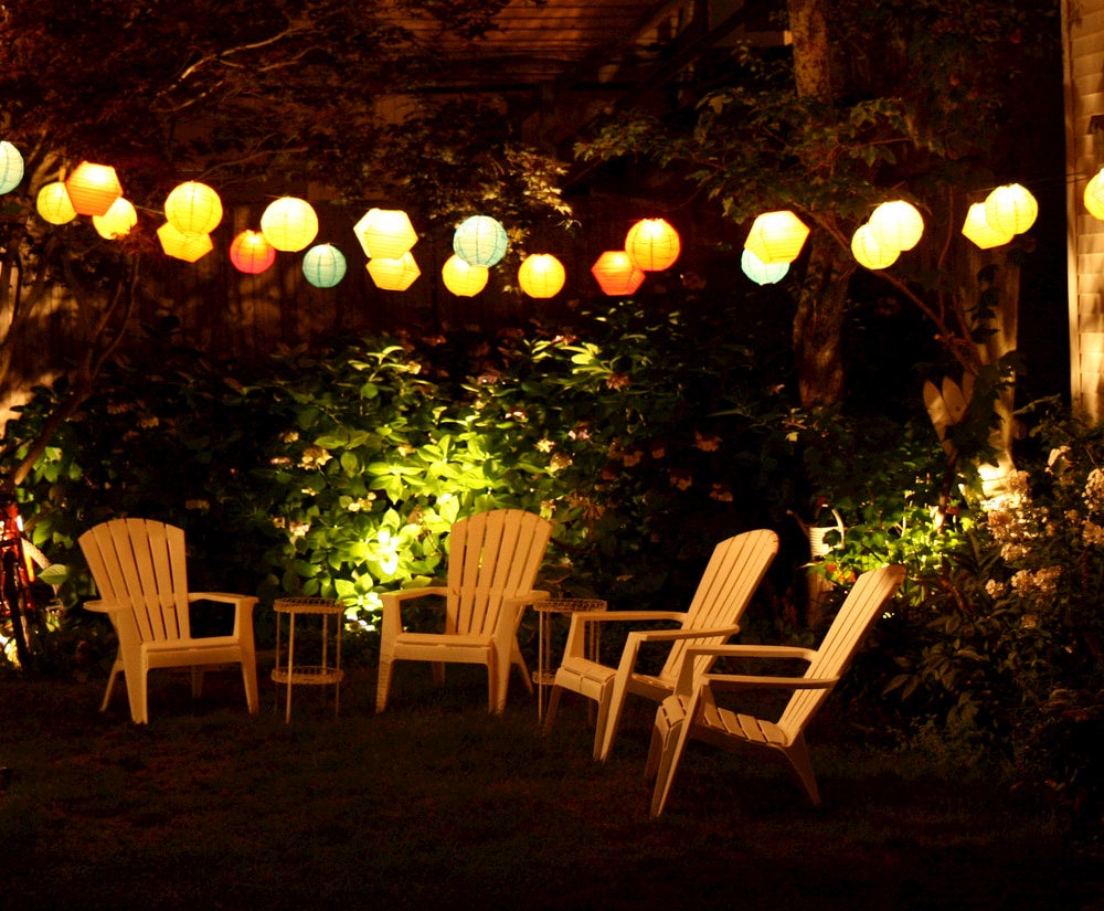 Paper lanterns hanging over chairs in background 