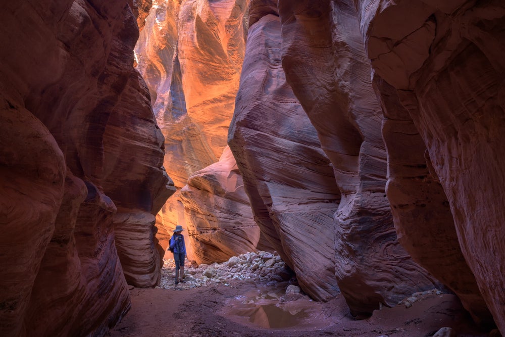 Person standing in Buckskin Gulch slot canyon