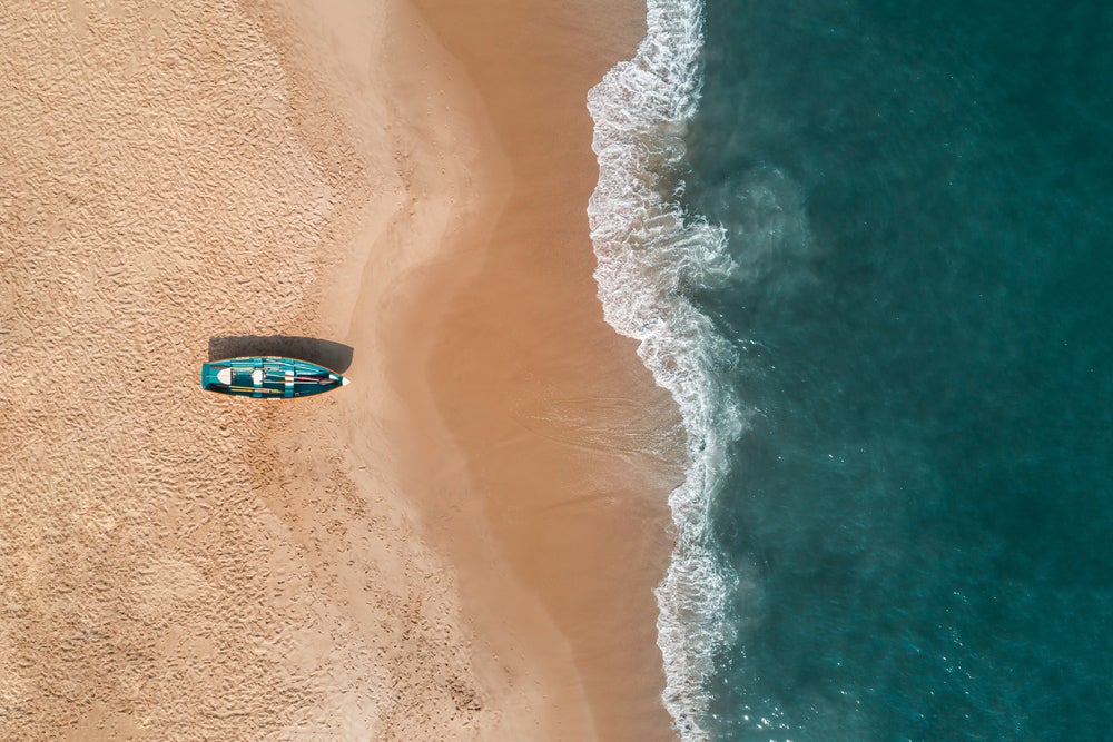 Aerial view of Cape May with a life guard boat on the beach.