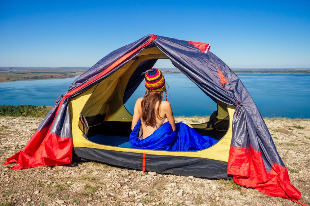 Naked Women in a tent and sleeping bag.