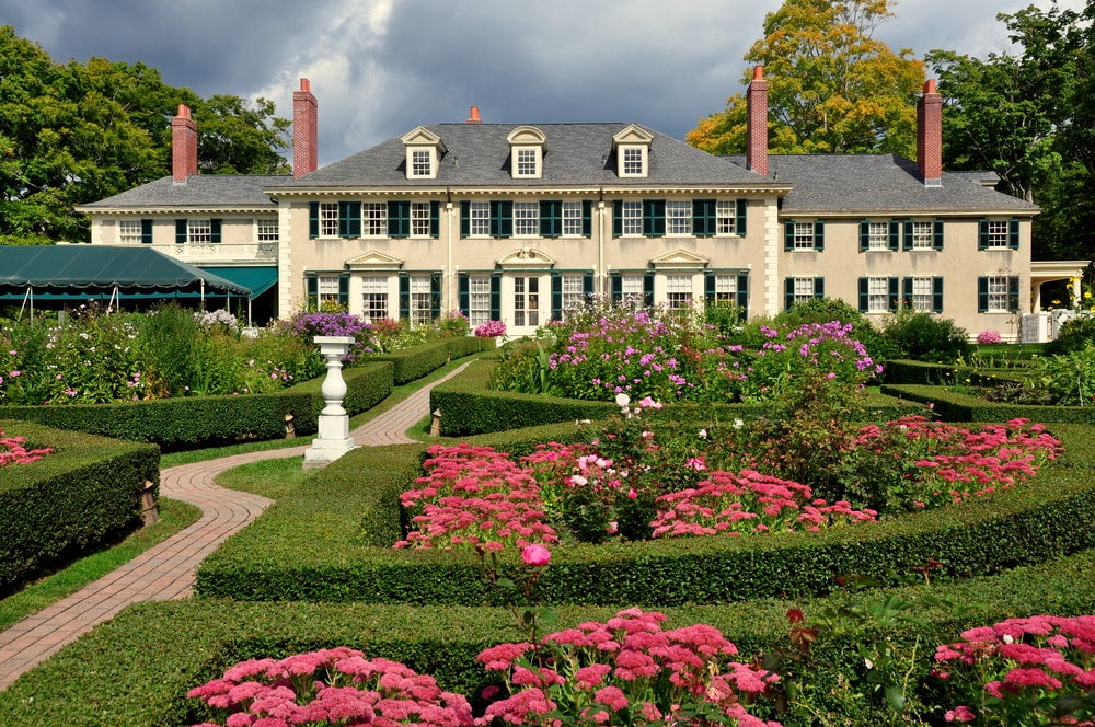Pink flowers and gardens surround the Hildene estate house