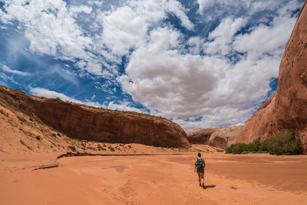 Female hiker walking into the brimstone Gulch slot canyon.