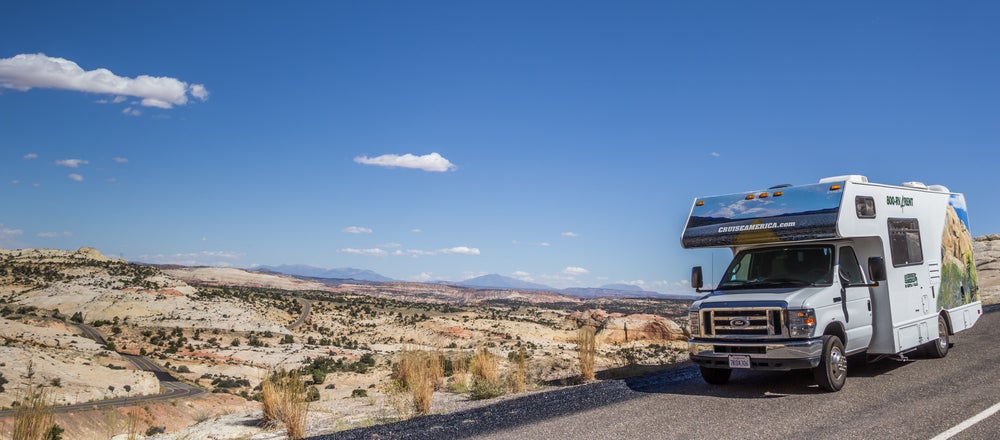 RV driving on highway 12 in utah in front of a dry desert