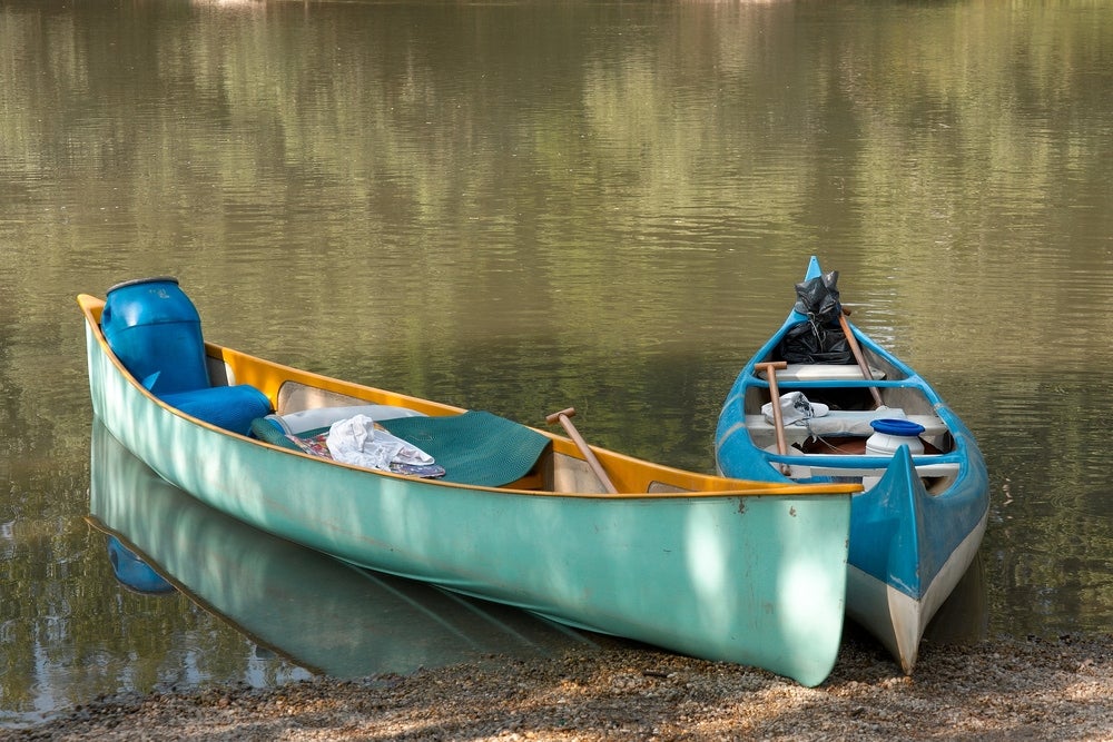 Tied up canoes filled with camping gear.