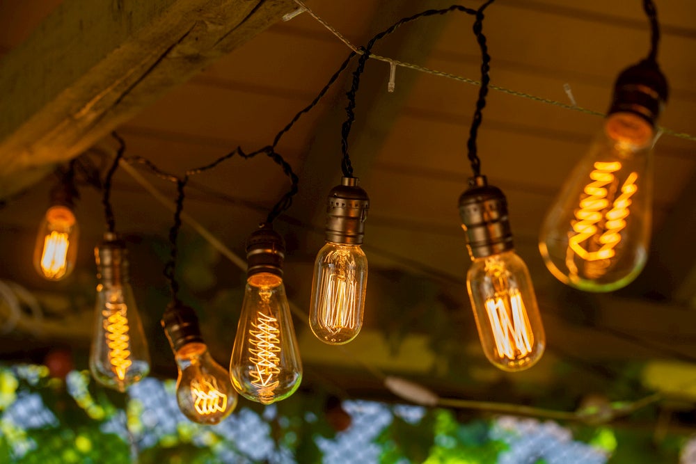 Edison lightbulbs on a string hung from a roof