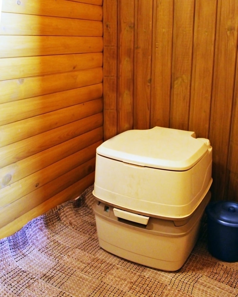 Boxy composting toilet with lower compartment.