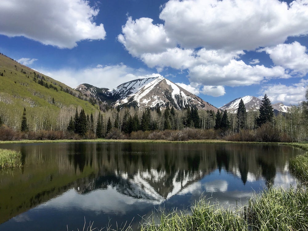 Snow capped peak against a mirror lake 